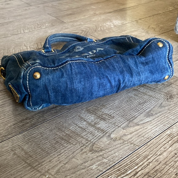 This is a Prada denim tote bag. No rips or tears, just minor wear from use. - Picture 7 of 9